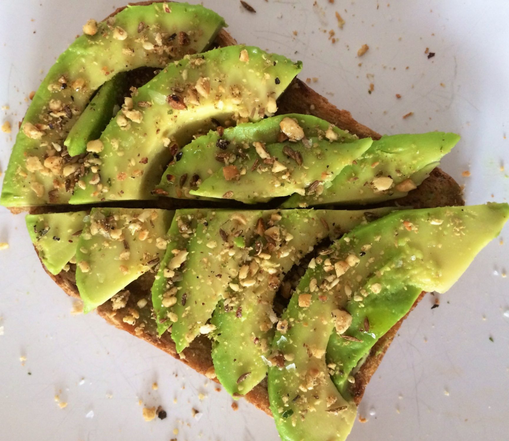 Eating toast (with avocado and dukkah).