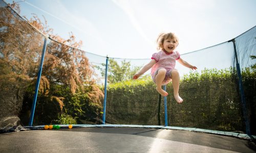child jumping on trampoline