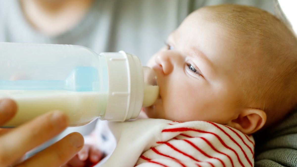 Baby drinking formula from bottle