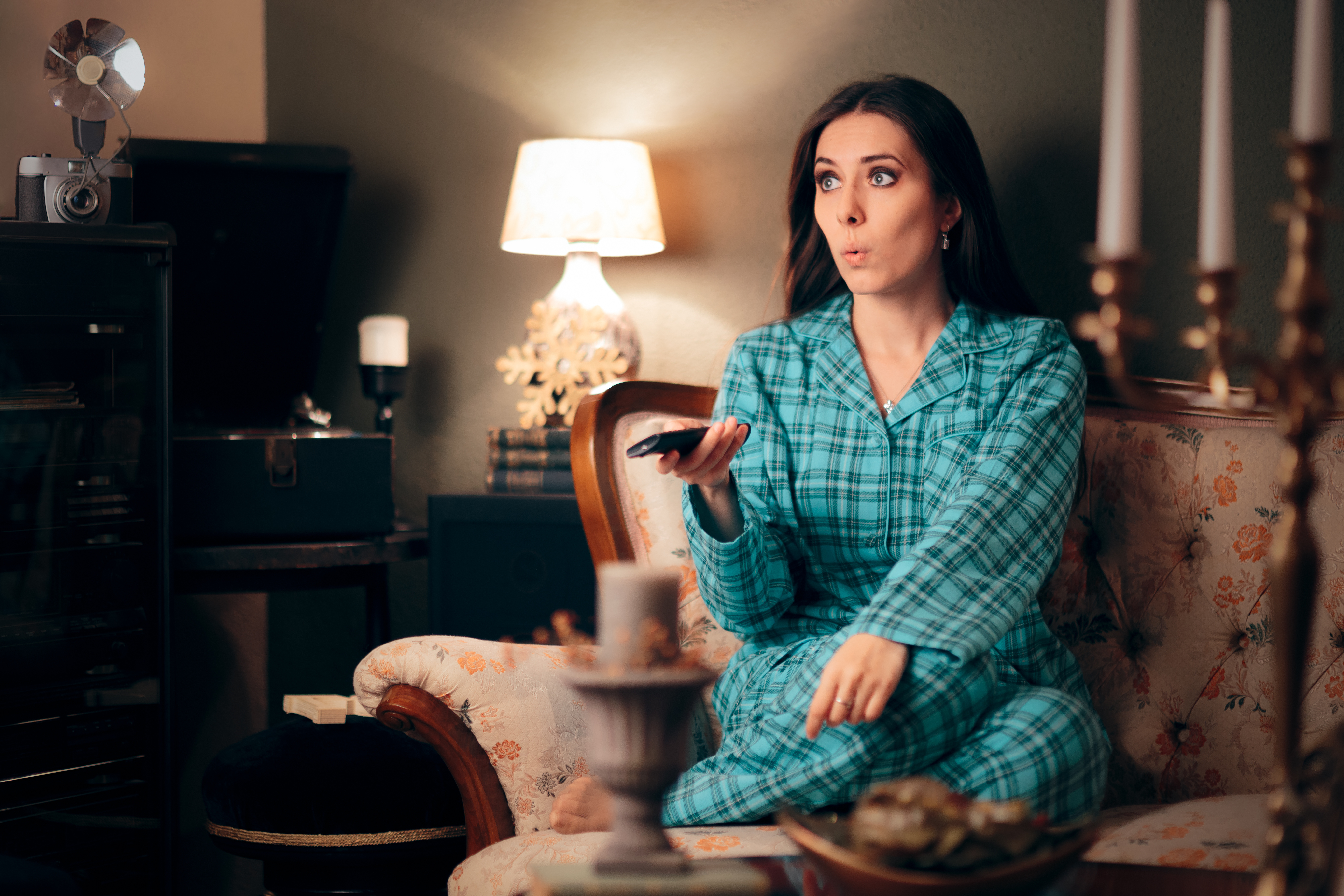 Woman in pajamas watching tv