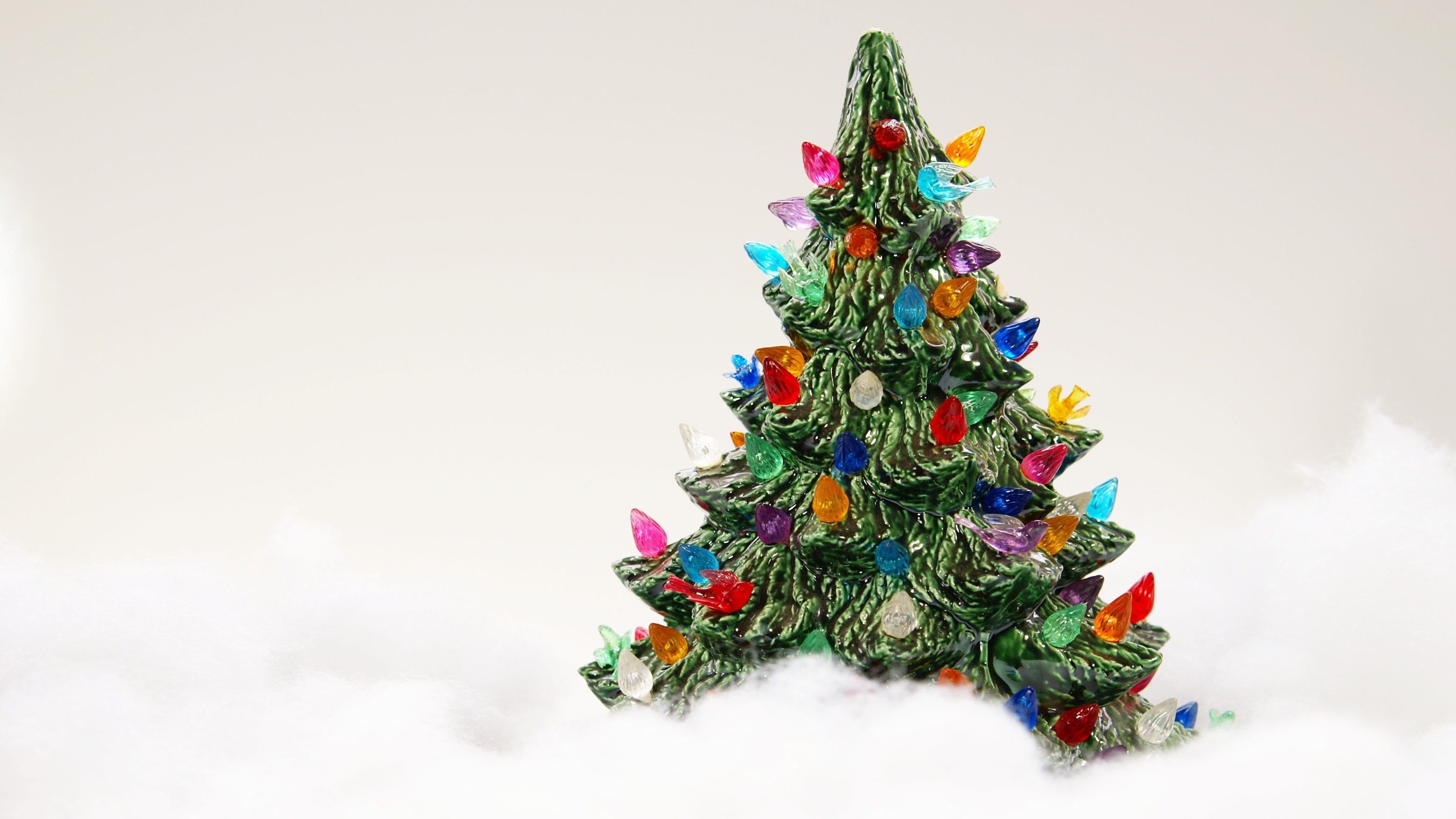 Ceramic Christmas tree surrounded by fake snow