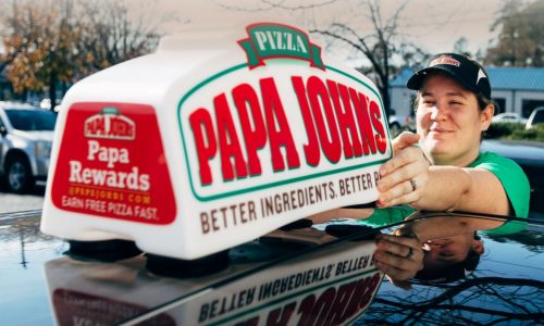 Papa John's sign on top of car