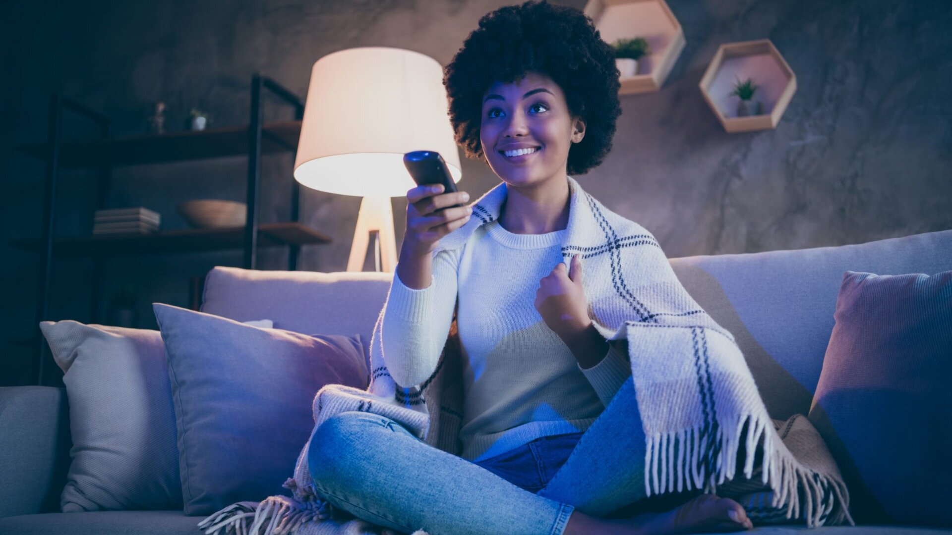 Woman watching TV on couch