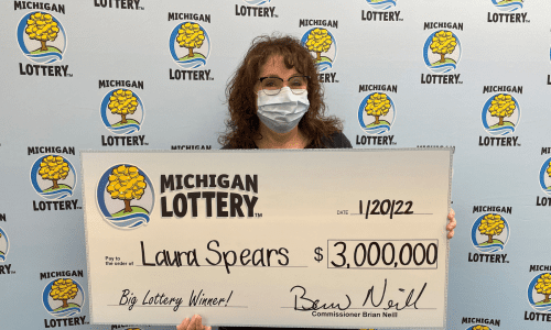 Laura Spears holds Michigan Lottery check