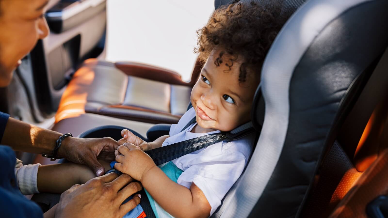 Cute baby smiles in car seat