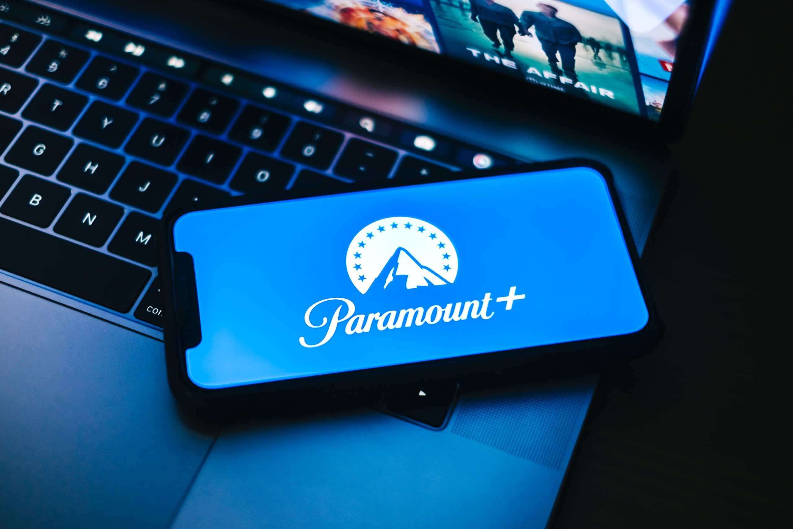 Paramount Plus logo on phone and laptop