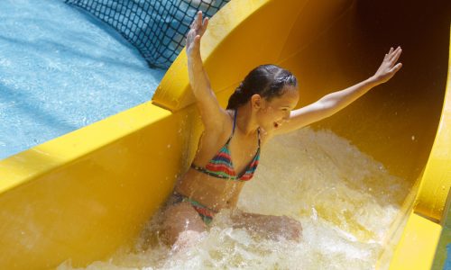 Girl enjoys water park slide
