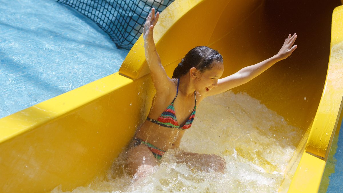 Girl enjoys water park slide