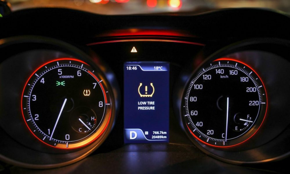 Low tire pressure error sign. Warning lights flash on a car's display screen.