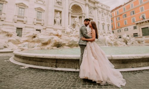 Bride, groom pose at Italy's Trevi Fountain