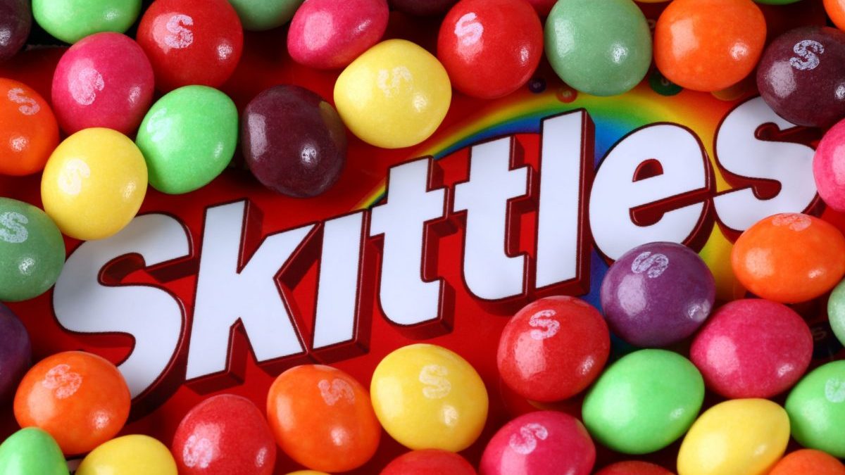 The Skittles logo is surrounded by the colorful candies.