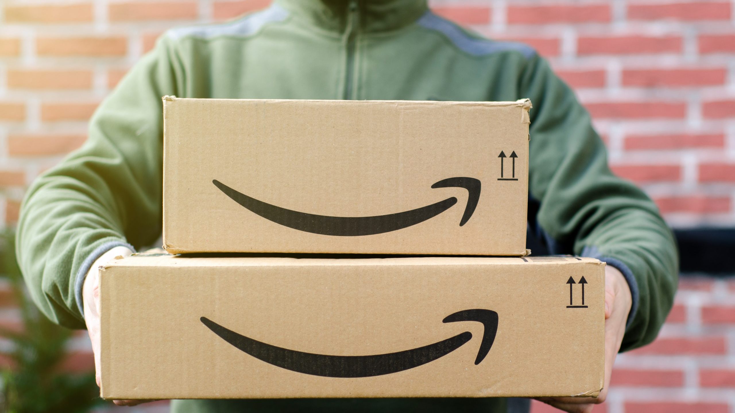 Man holds Amazon boxes