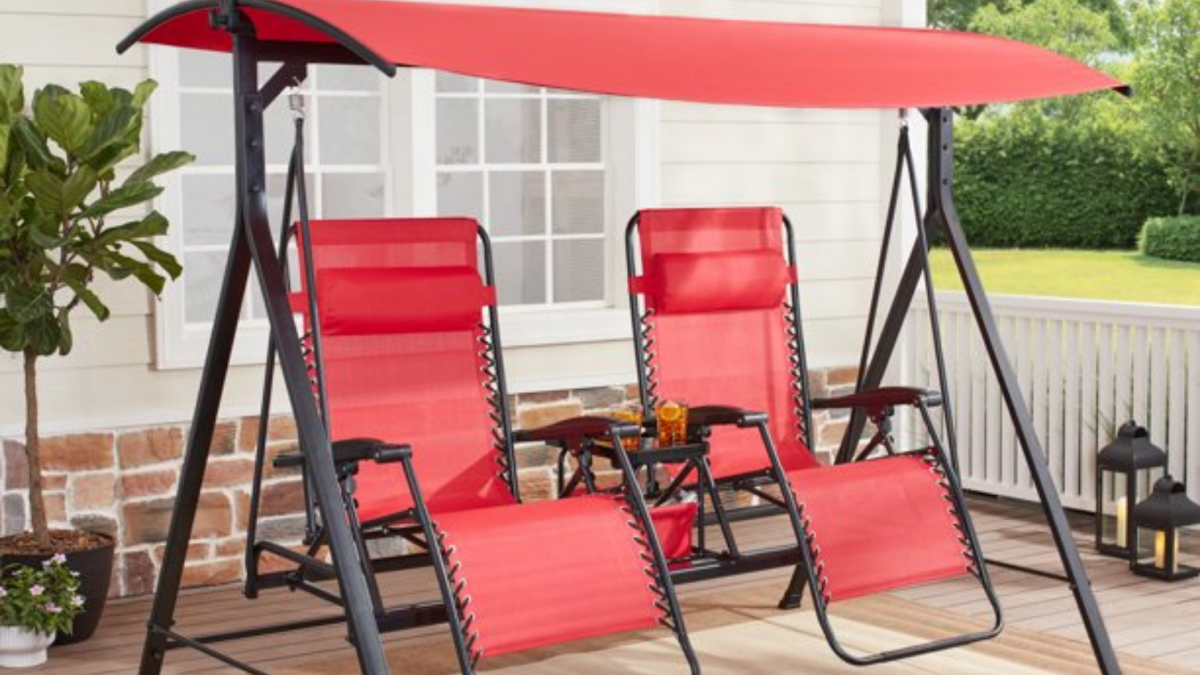 A red two-person zero-gravity porch swing is shown.