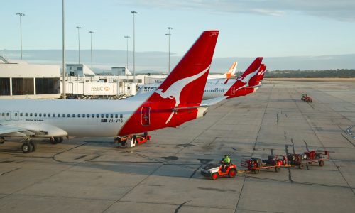 Luggage handlers approach Qantas airplanes
