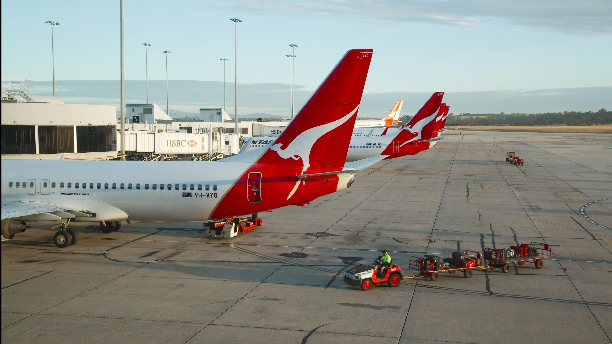 Luggage handlers approach Qantas airplanes
