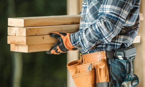 Contractor holds wood beams