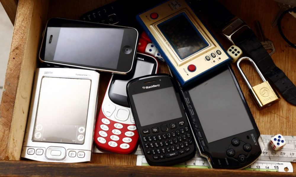 Old and vintage electronics gadgets or devices inside a drawer.