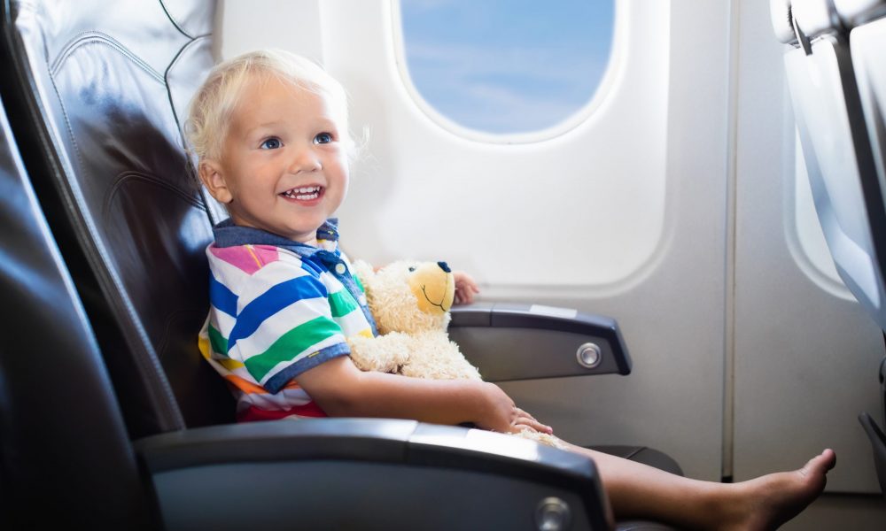Happy child passenger on airplane