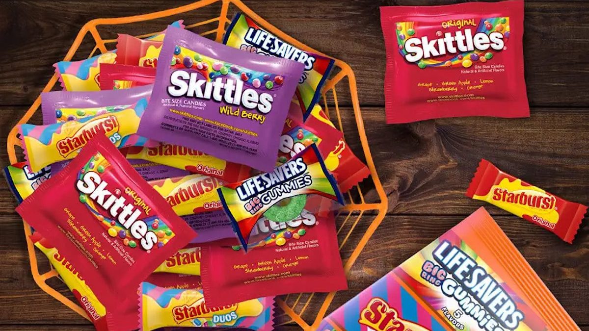 A mixed bowl of Halloween candy, including Skittles and Starburst.