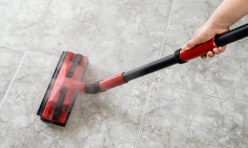 woman cleaning floor steam cleaning