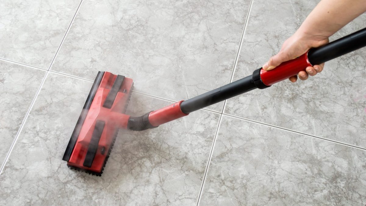 woman cleaning floor steam cleaning