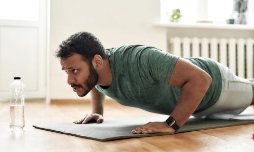Man performs push-up.