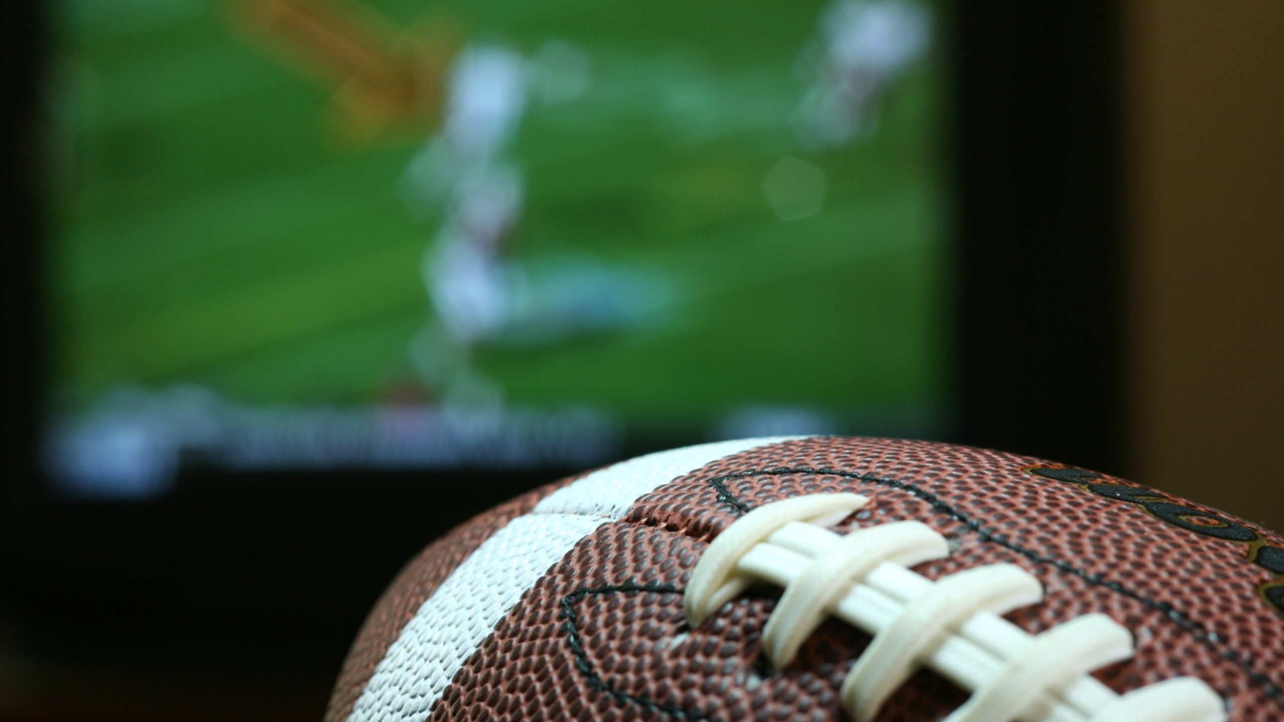 Football in front of TV screen playing game
