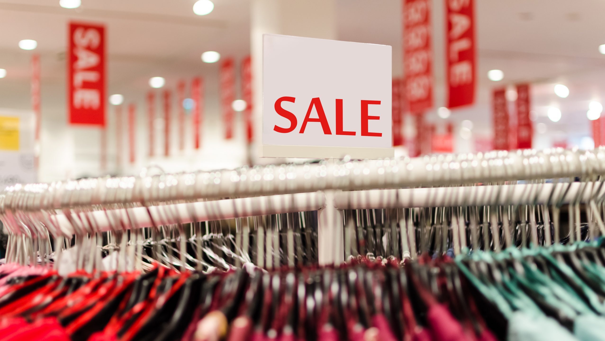 sale sign on clothing rack