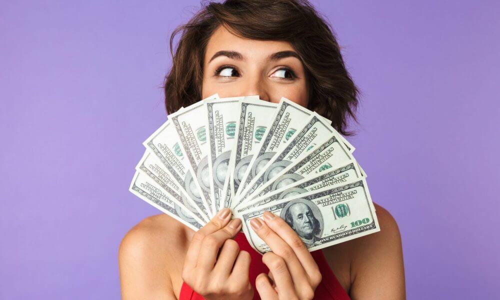 Woman holds cash money