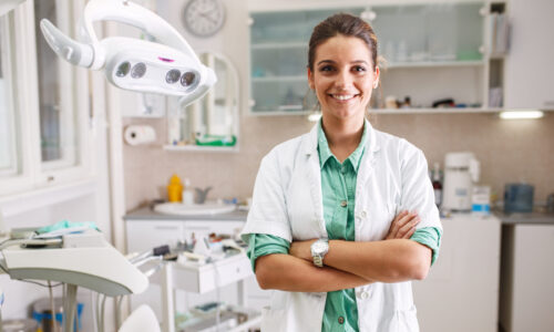 Periodontist or dentist at work in her office