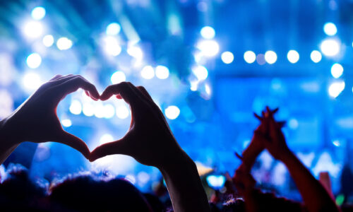 Hands form heart with hands at live concert