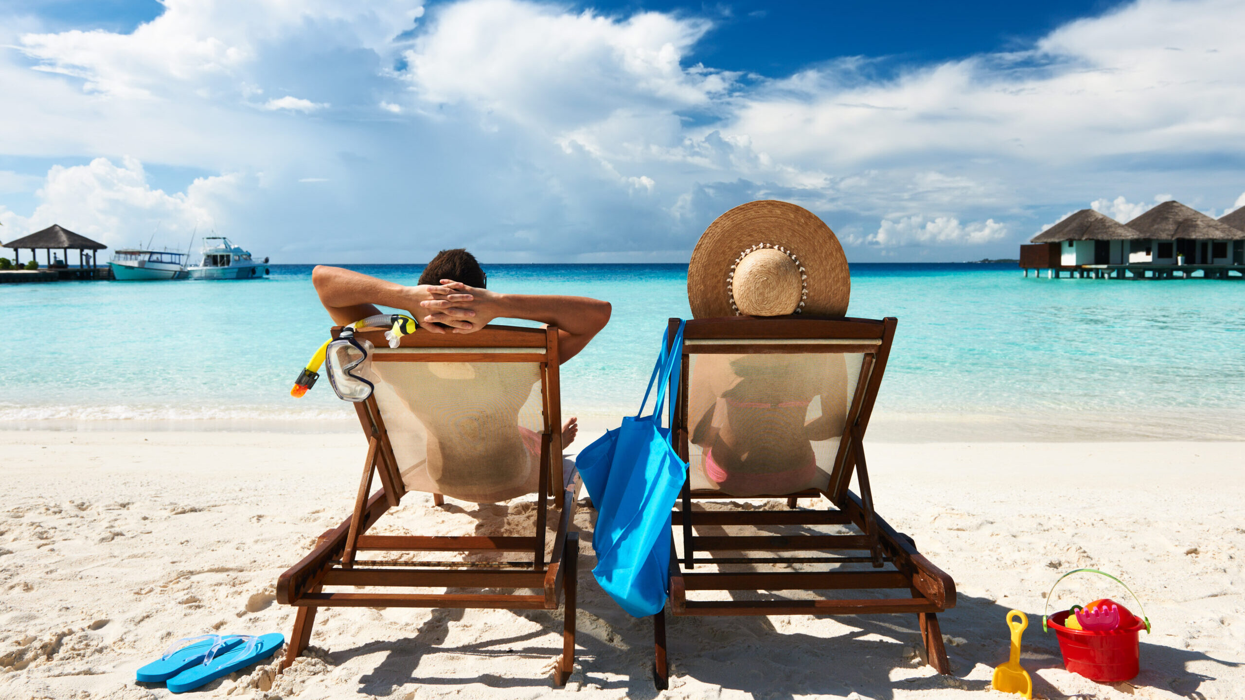 Couple in lounge chairs on beach vacation