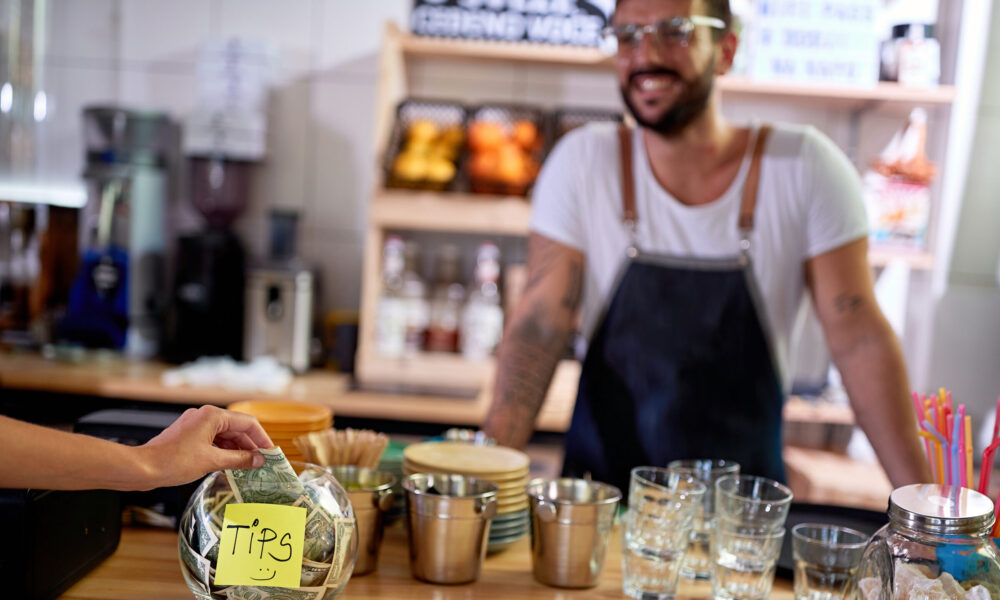 Customer places cash in tip jar