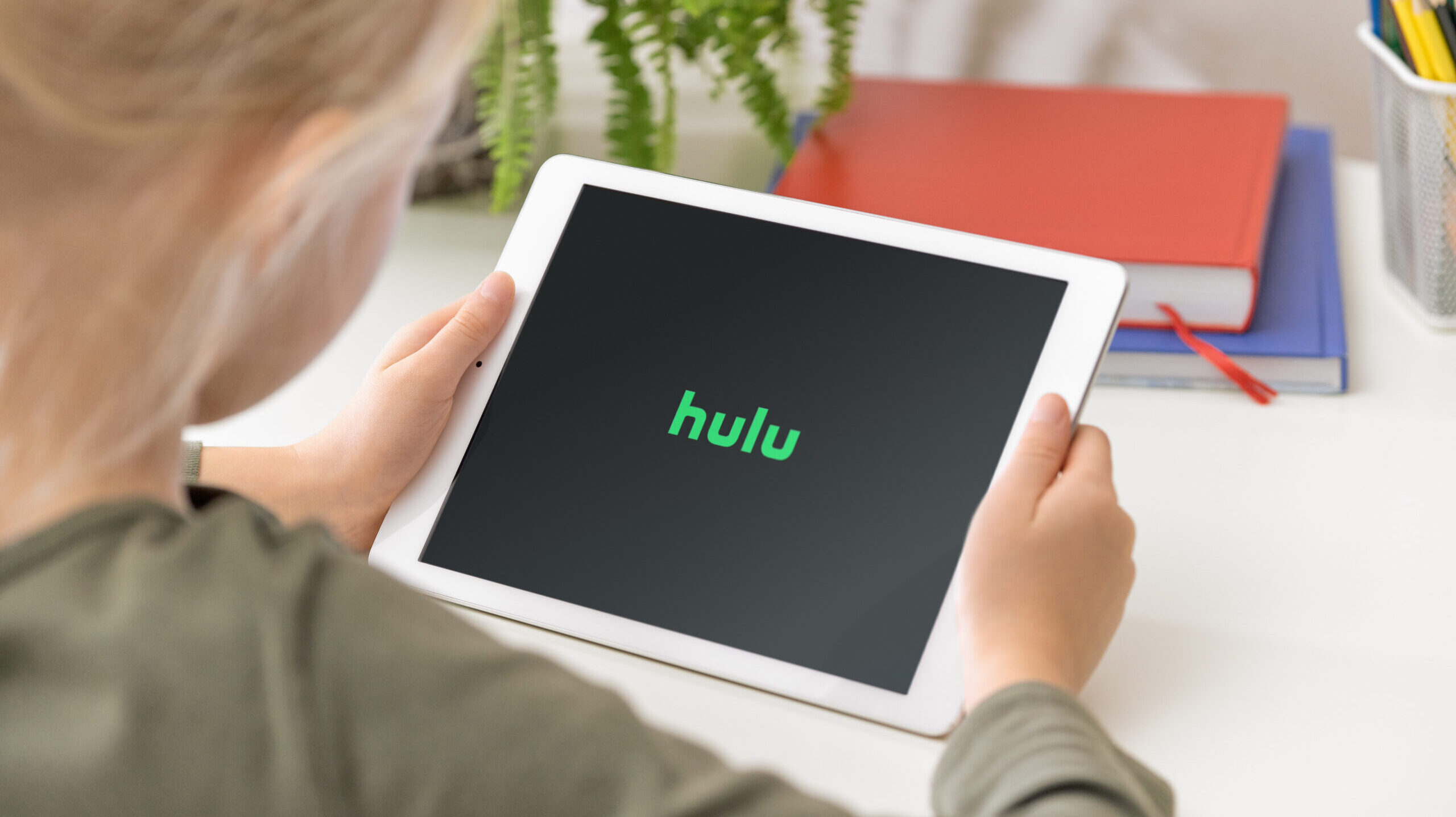 Woman watches Hulu on tablet