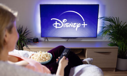 Woman watches Disney+ on TV