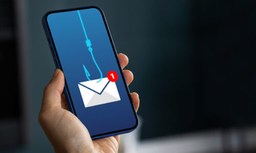 Hand holds phone showing email phishing illustration