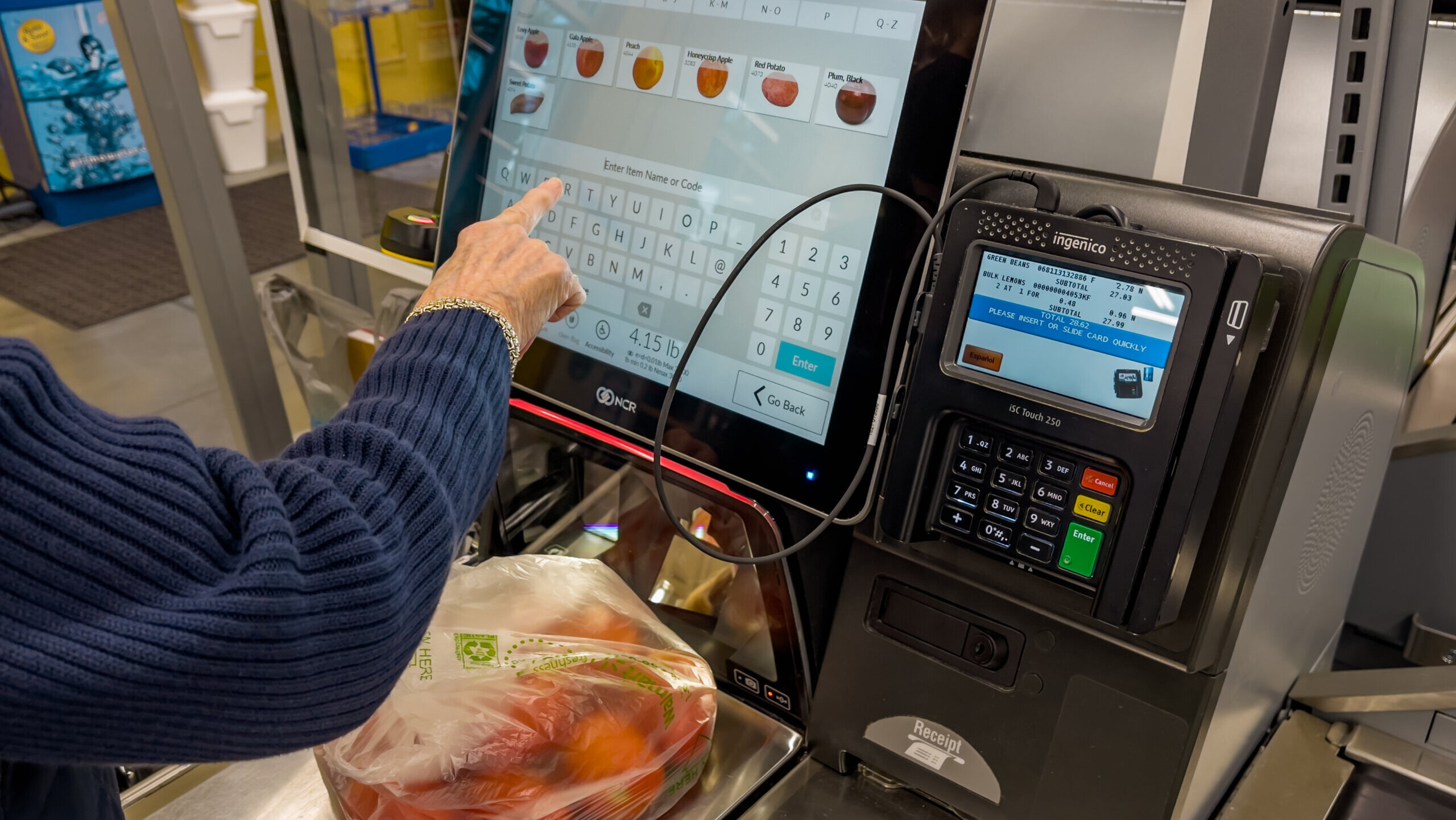 Grocery store customer has produce on self-checkout scale