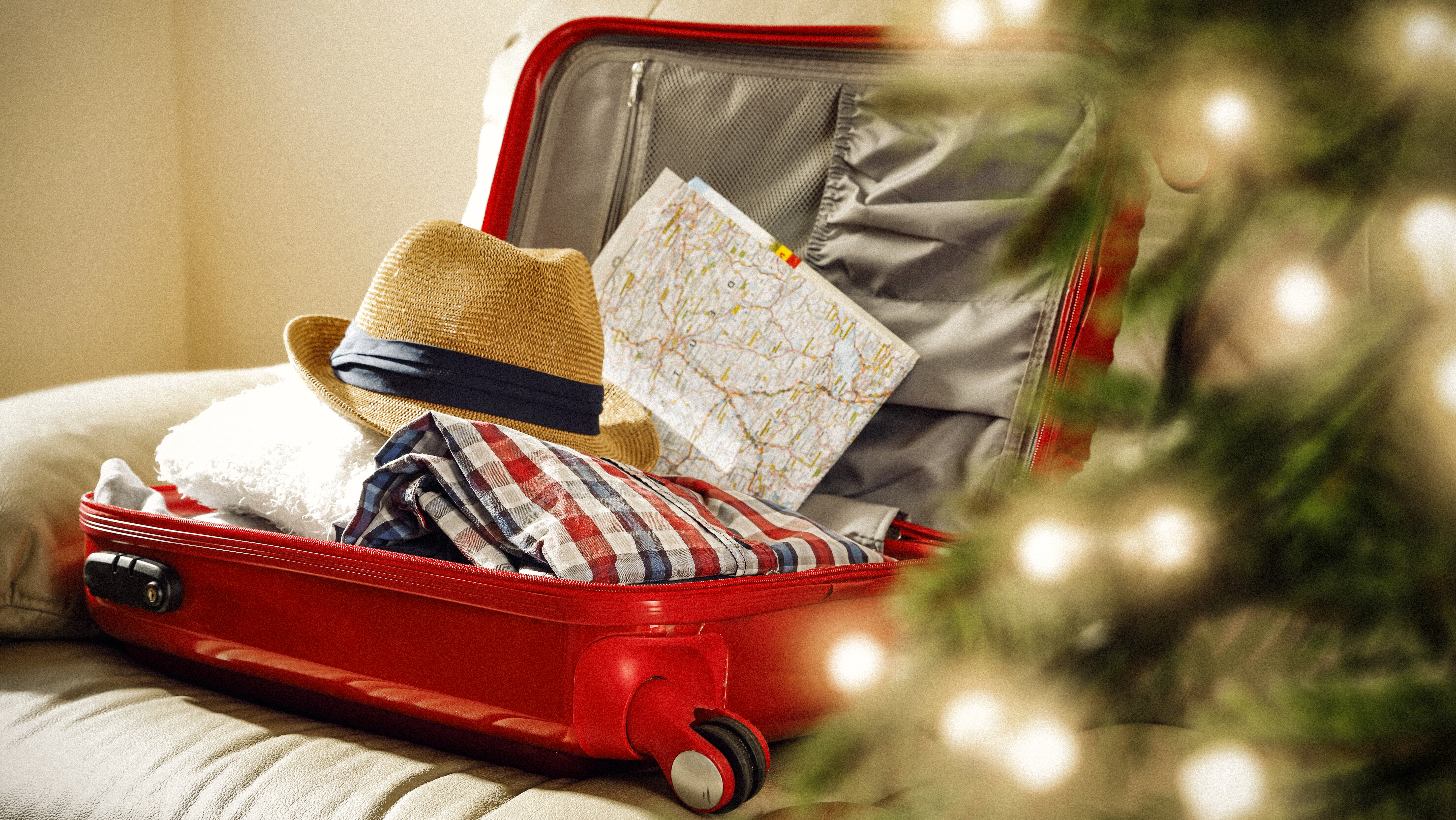 red suitcase and christmas tree decoration