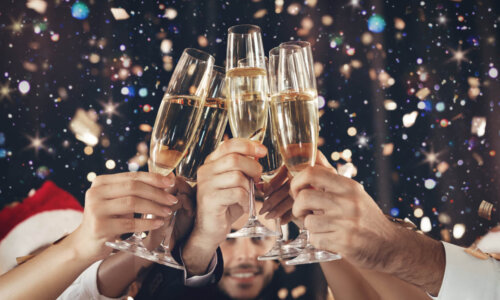 Hands raise champagne glasses for New Year's toast
