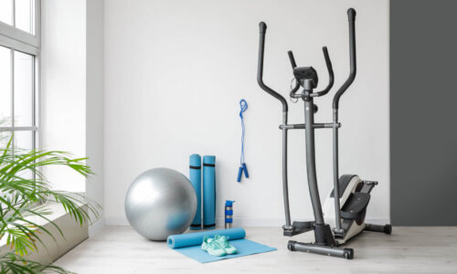 A home gym features an elliptical, resistance bands, a balance ball, and yoga mat.