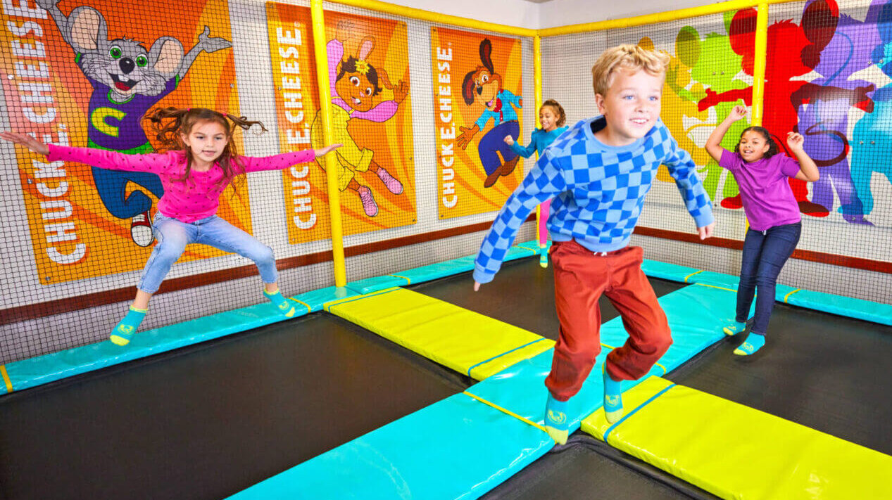 Children jumping on trampolines at Chuck E Cheese