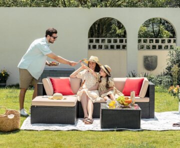A dad, mom, and daughter sit on a set of Devoko outdoor furniture.